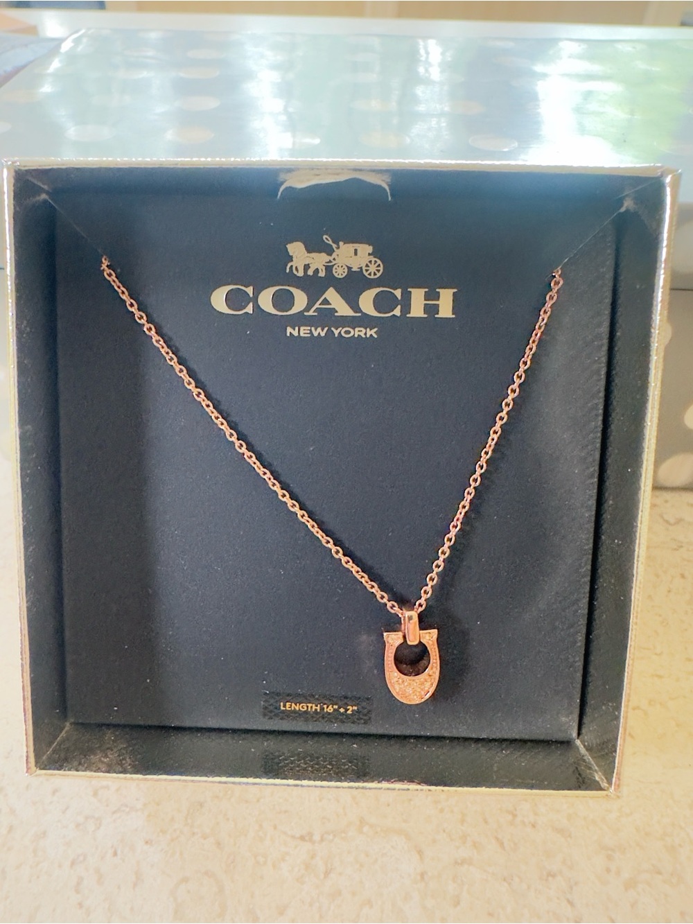 Coach “Rose Gold” color had Crystals in Horseshoe Pendant Necklace